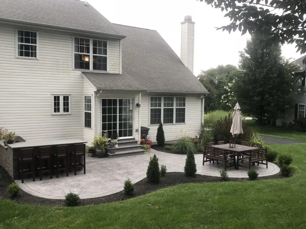 Furnished patio with gray stamped concrete with paver pattern